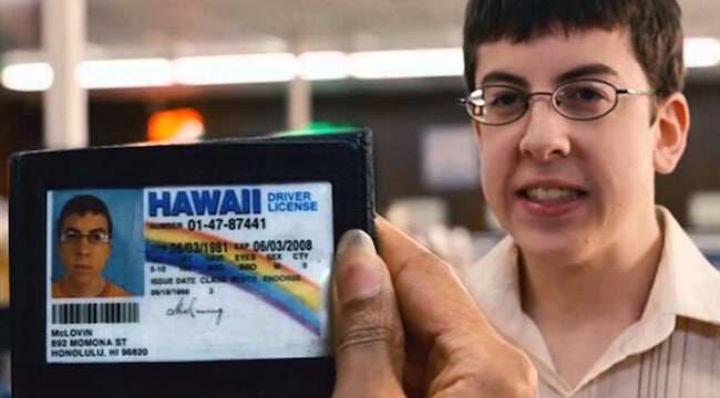 McLovin from Superbad in the background, while the clerk looks at his obviously fake Hawaii driver's license in the foreground