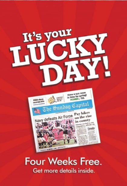 A bright red postcard with "It's your LUCKY DAY" over the image of a newspaper. Under the newspaper, it says "Four Weeks Free. Get more details inside."